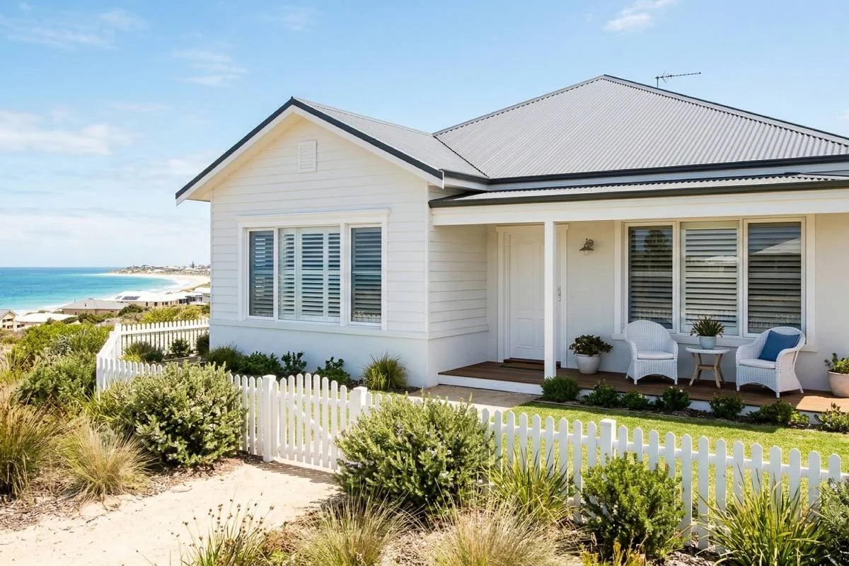 White Hampton-style shutters on the front windows of a house