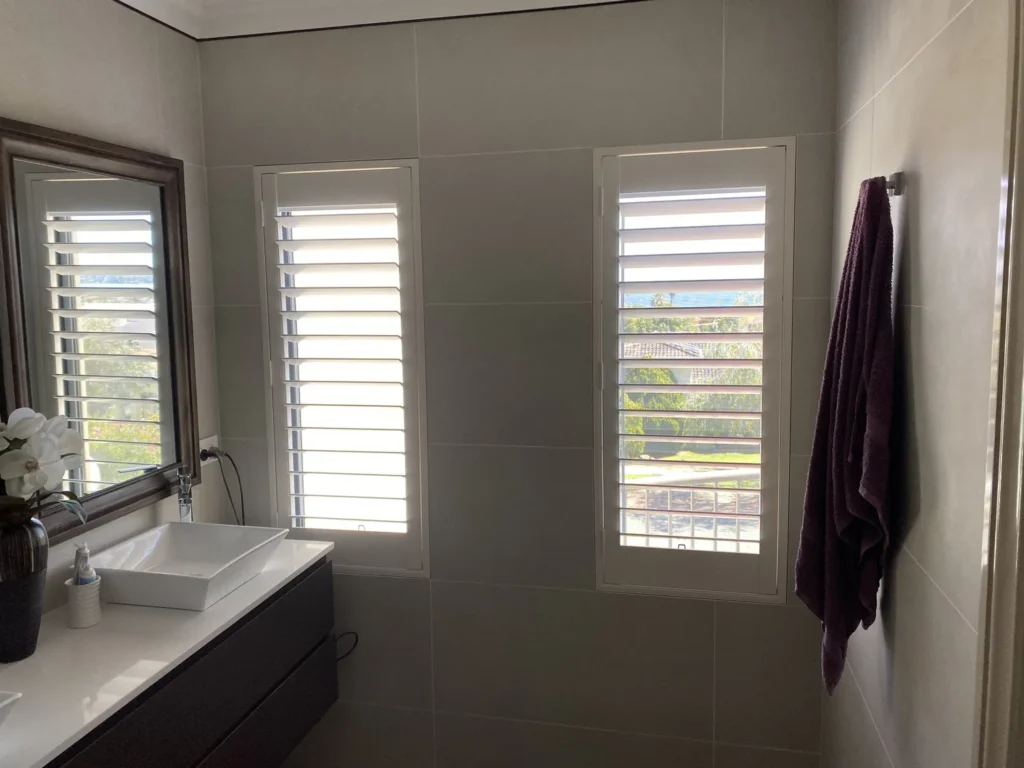 Moisture-resistant plantation shutters in a wet area
