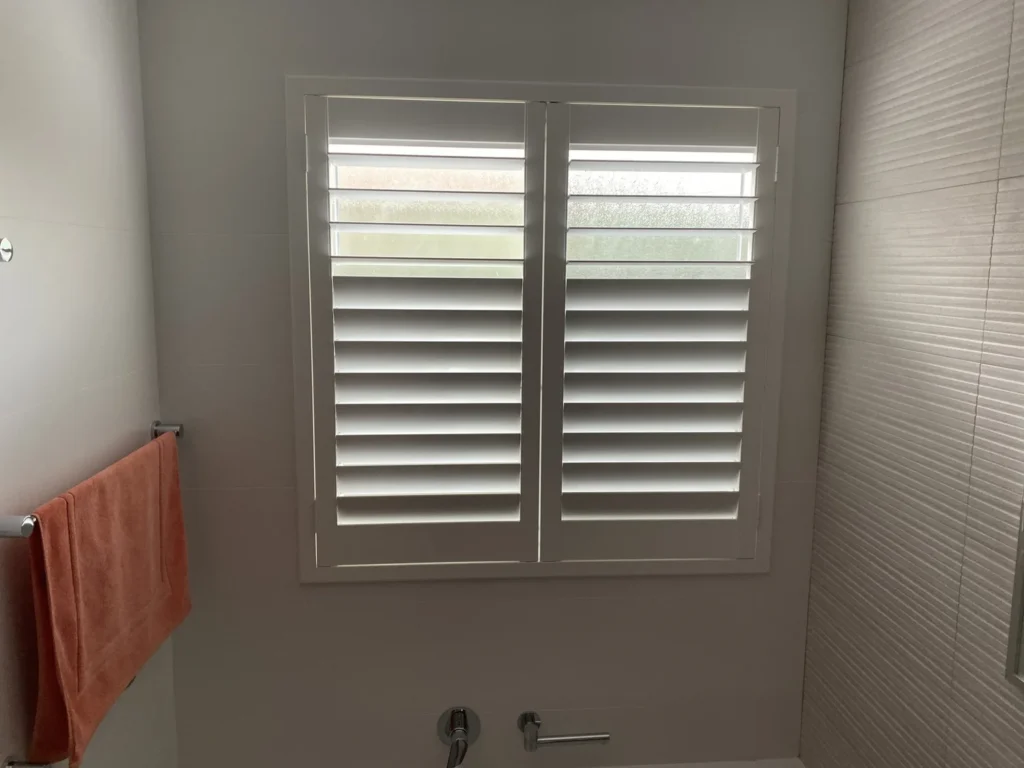 Moisture-resistant plantation shutters in a wet area
