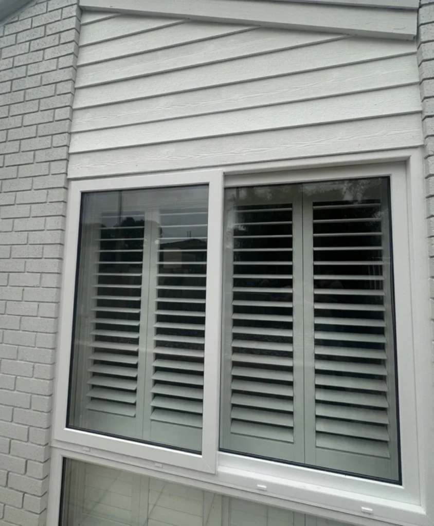 New window with plantation shutters fitted behind the glass