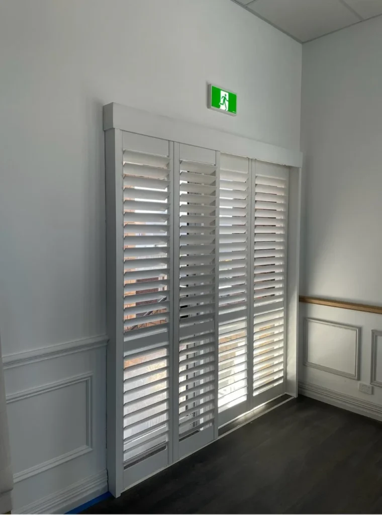 Sliding plantation shutters across a wide opening