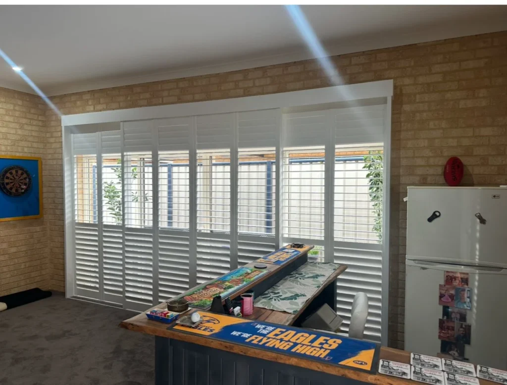 Sliding plantation shutters across a wide opening
