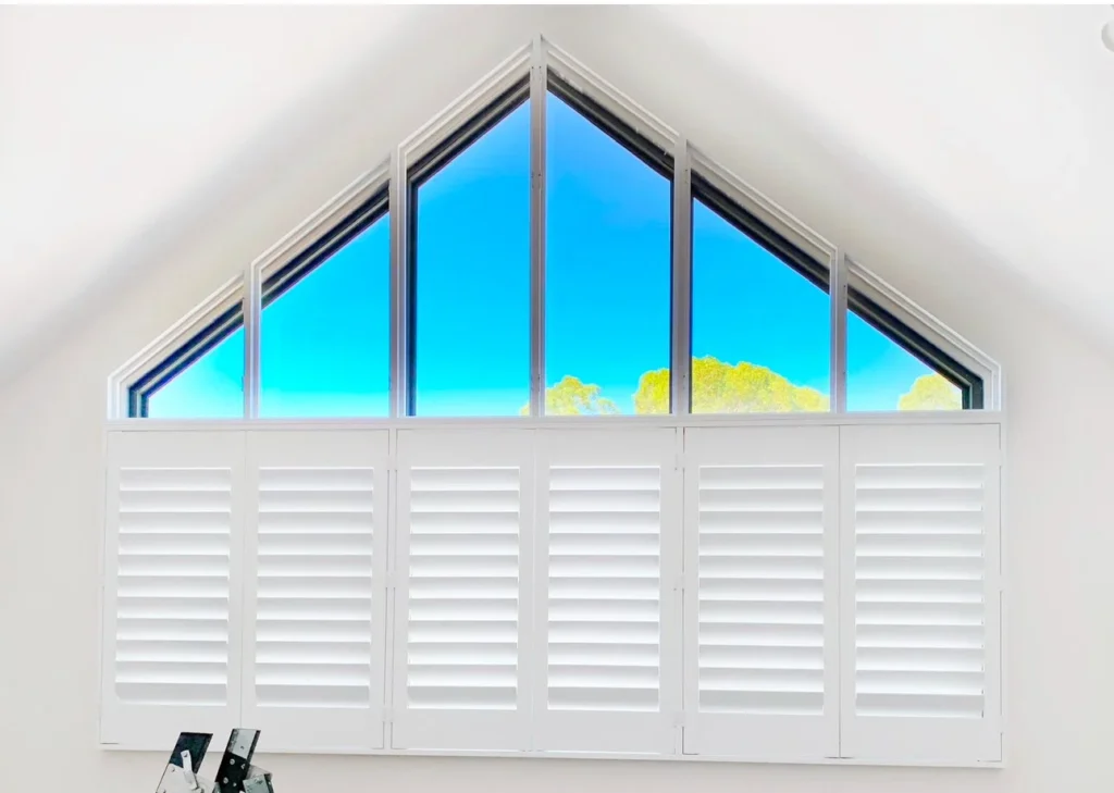 Shutters on a raked window