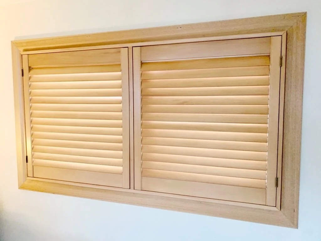 Close-up of stained timber plantation shutters with the louvres open