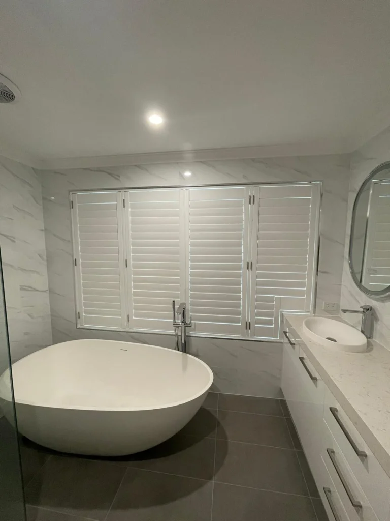 Moisture-resistant plantation shutters in a wet area
