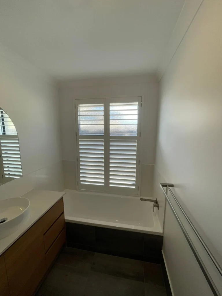 Moisture-resistant plantation shutters in a wet area