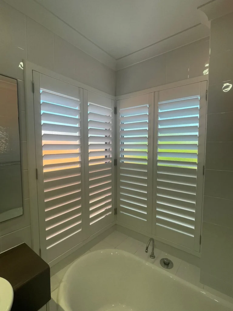 Moisture-resistant plantation shutters in a wet area