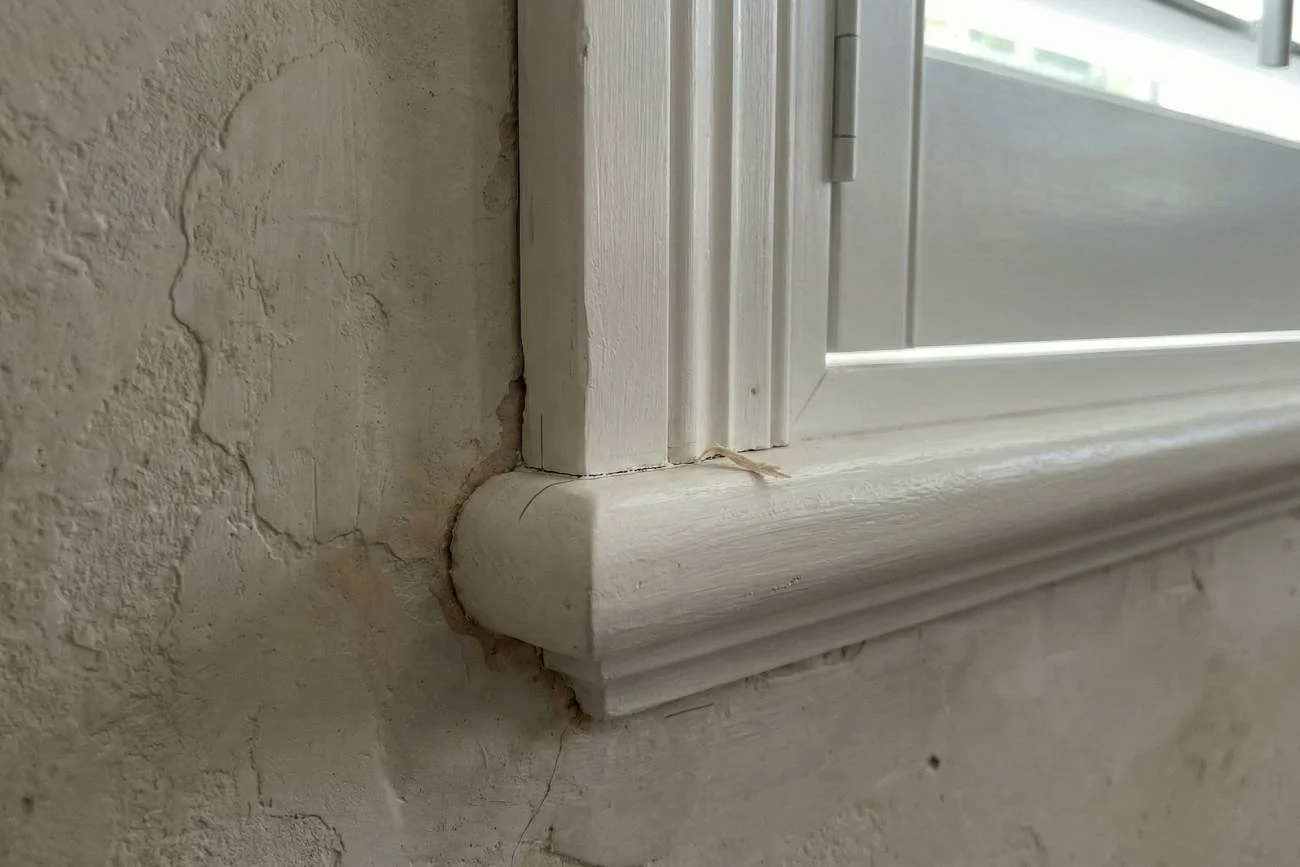 Shutter frame scribed to sit flush against an uneven wall