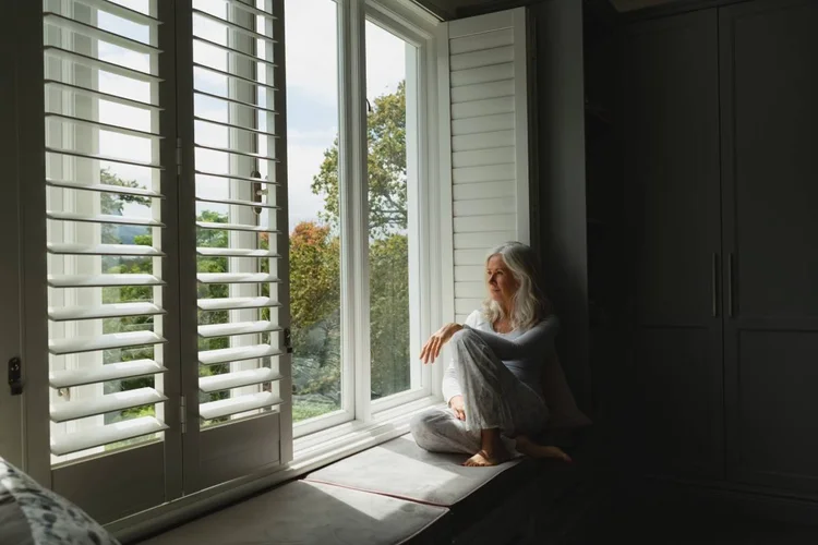 Woman thinking beside a window