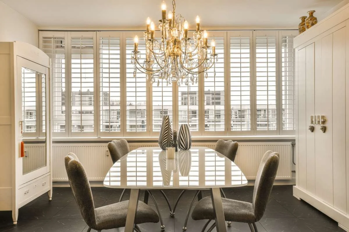 Modern dining room with plantation shutters on the windows